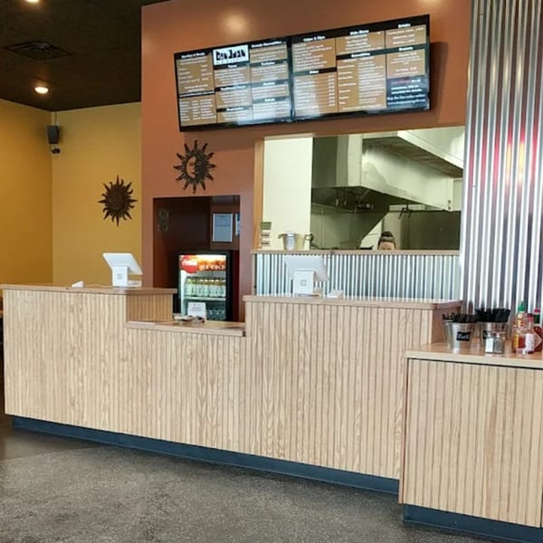 Don Juan Mex Grill's counter area with menus, POS systems, and a peek into the kitchen.